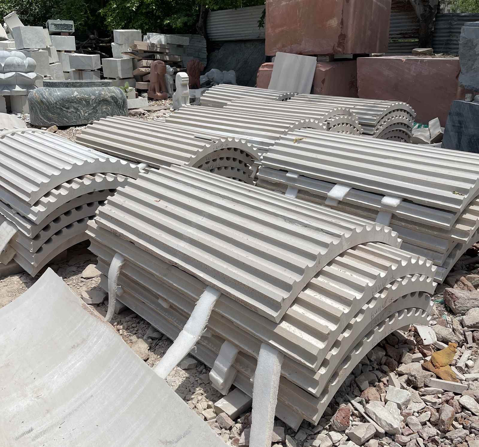 Carved stone pieces stacked in a stone yard