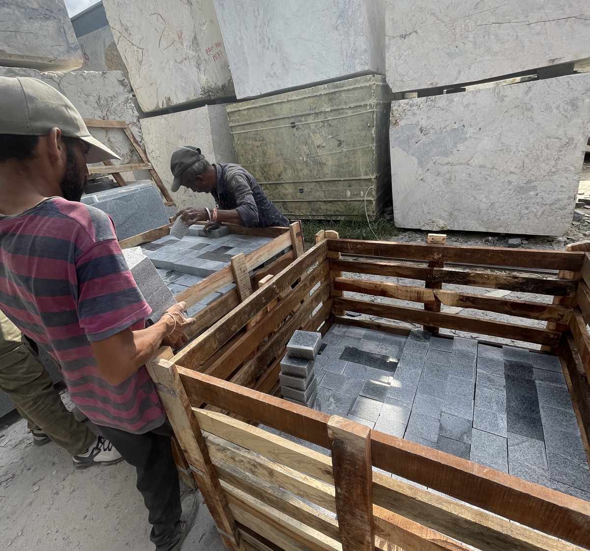 Stone setts being packed into a timber crate for dispatch