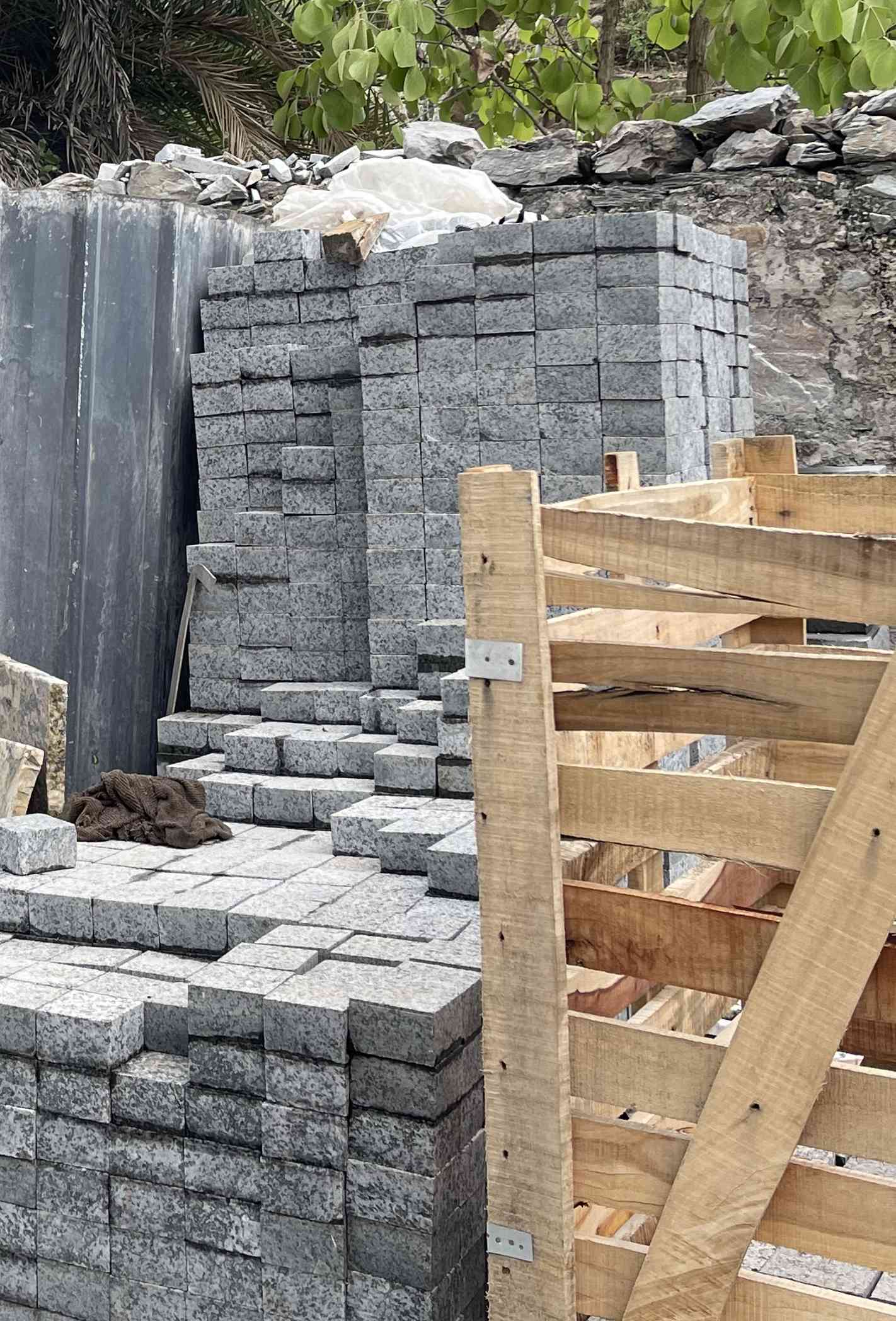 Stone setts stacked beside a timber crate